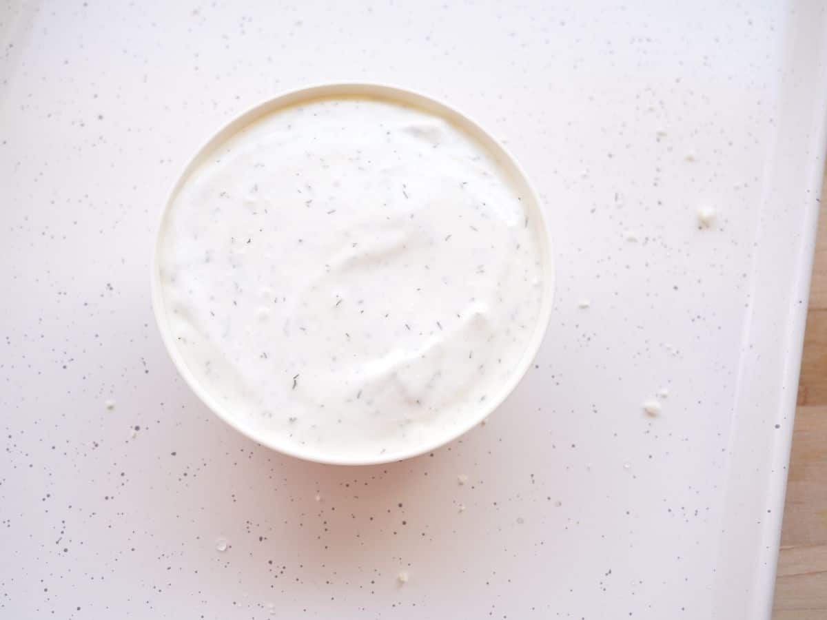vegetable dip in white bowl on easter tray