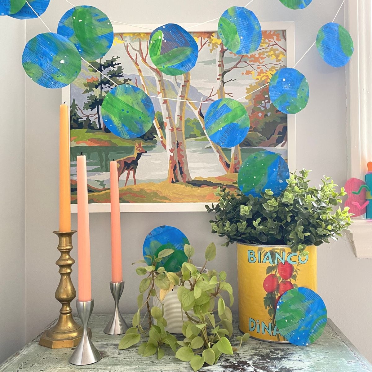 DIY Recycled Newspaper Earth Day Garland hanging with tablescape