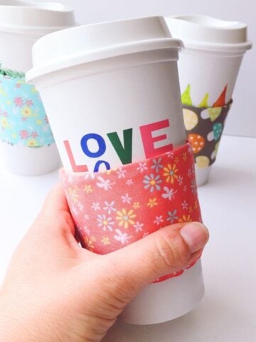 close up of diy coffee cup sleeve being held in woman's hand