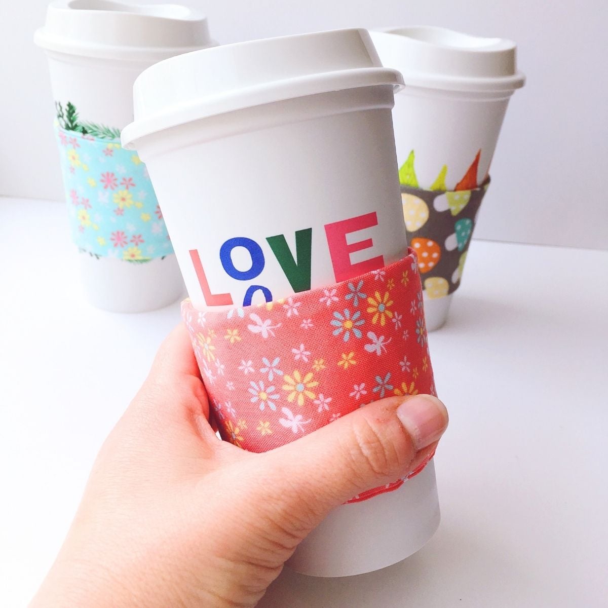 close up of diy coffee cup sleeve being held in woman's hand