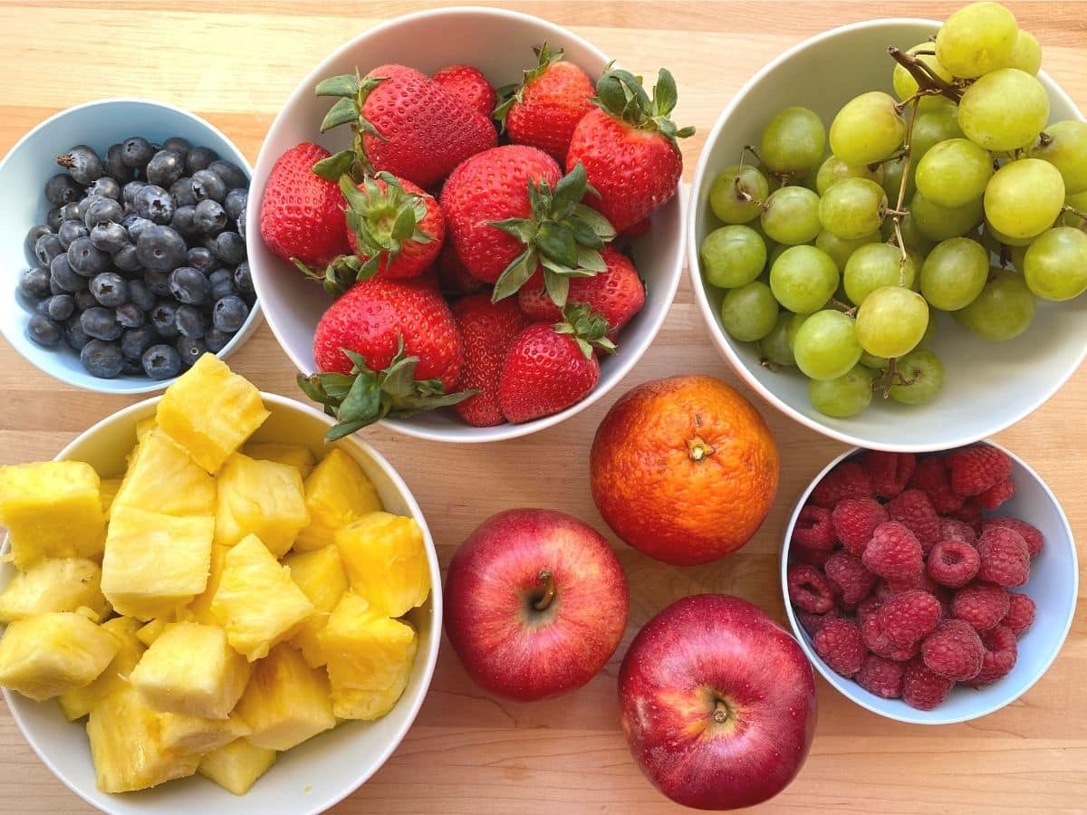 all the fruit for a fruit tray pineapple strawberries, grapes blueberries, raspberries and apple