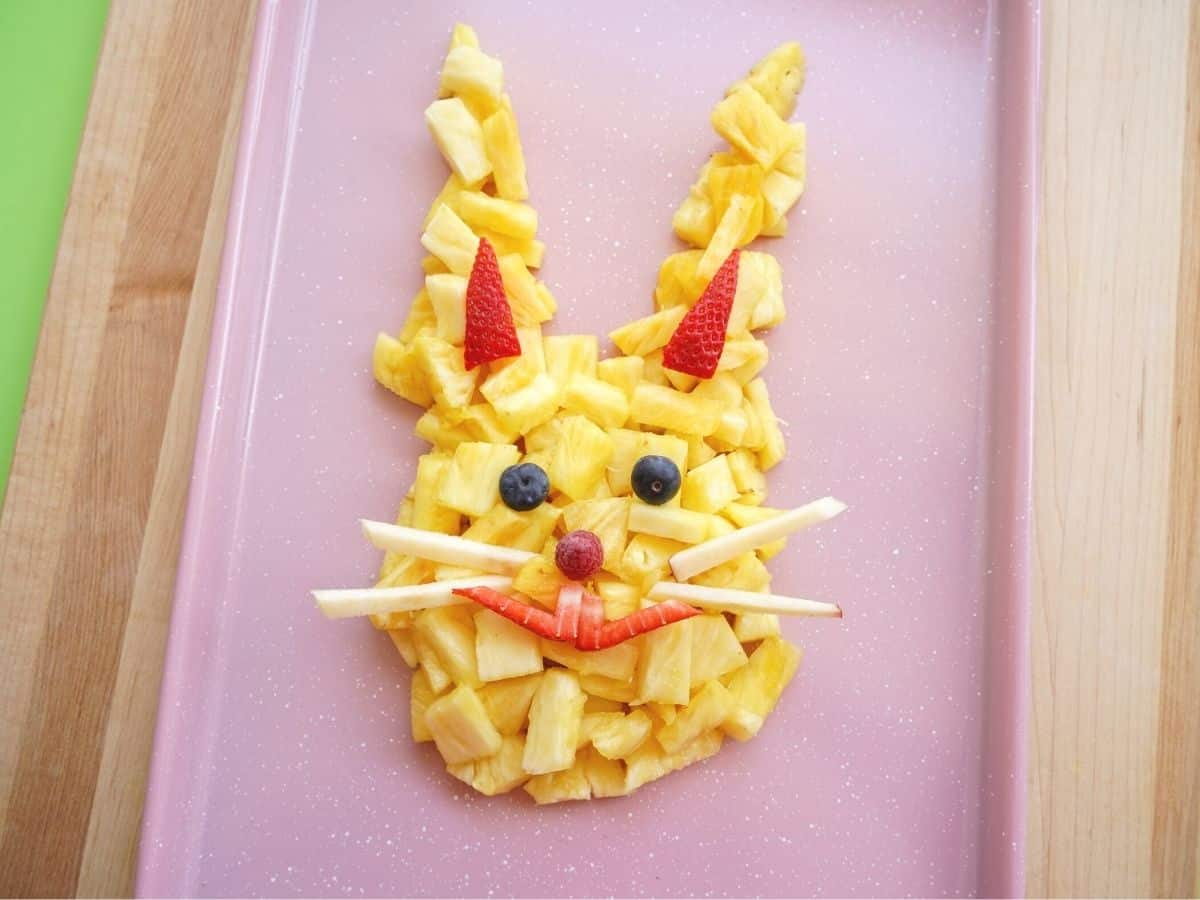 pineapple easter bunny head on platter with fruit face