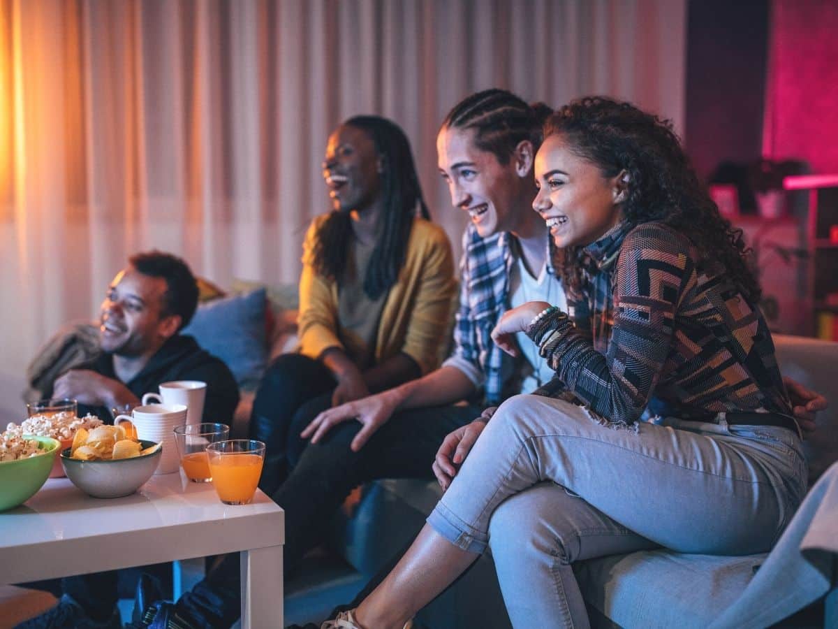 family and friends watching a summer movie in the livingroom