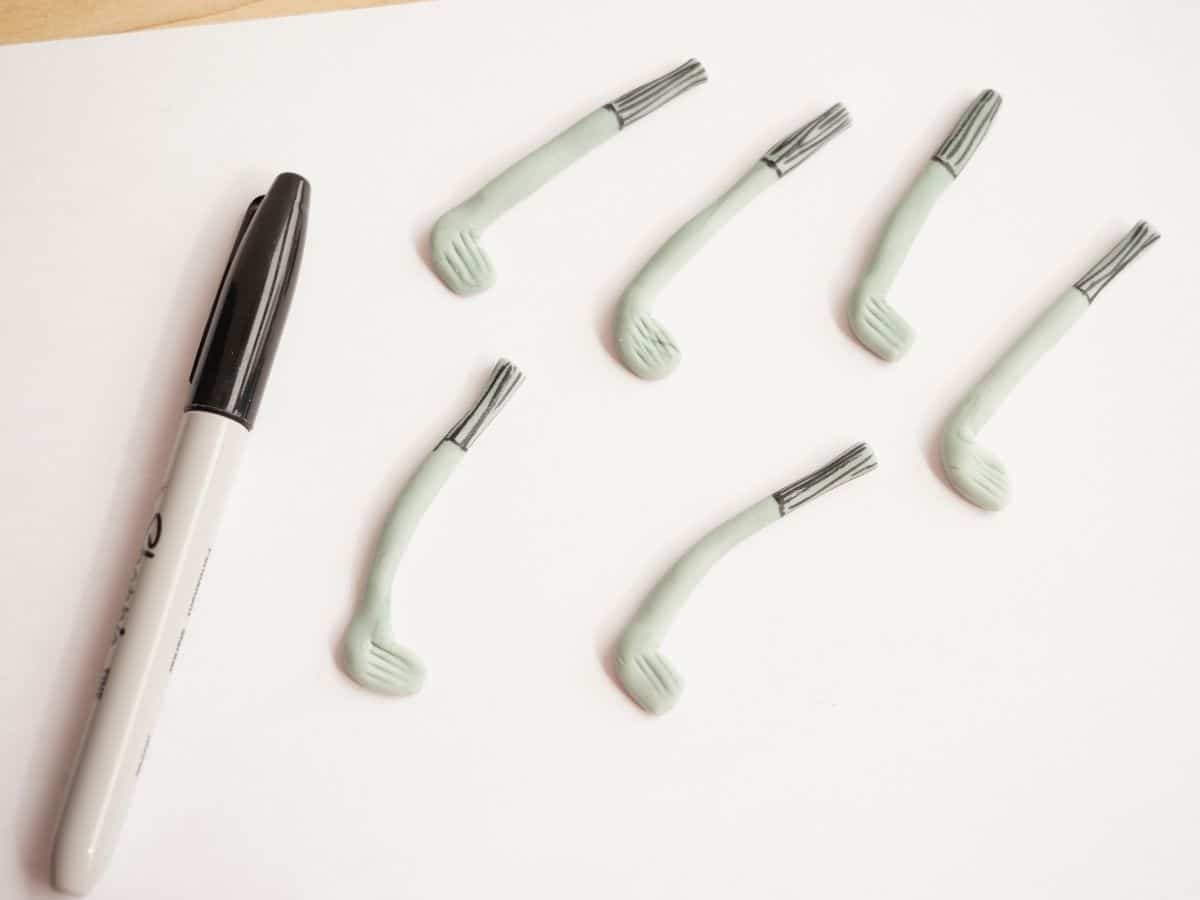 fondant golf clubs with black marker drawn on handles