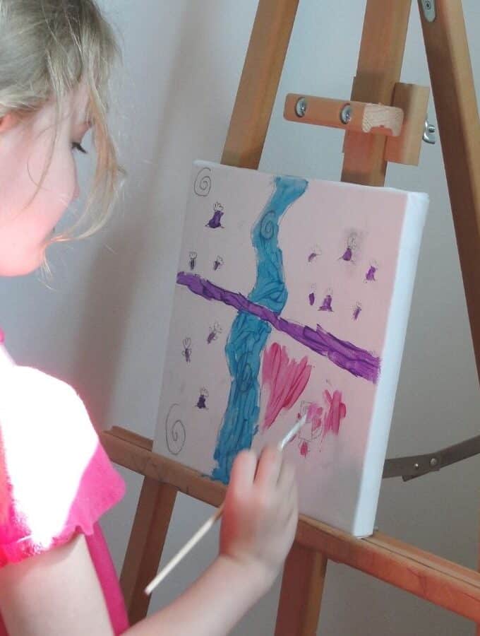 kid painting on an canvas at an easel rodrigue painting