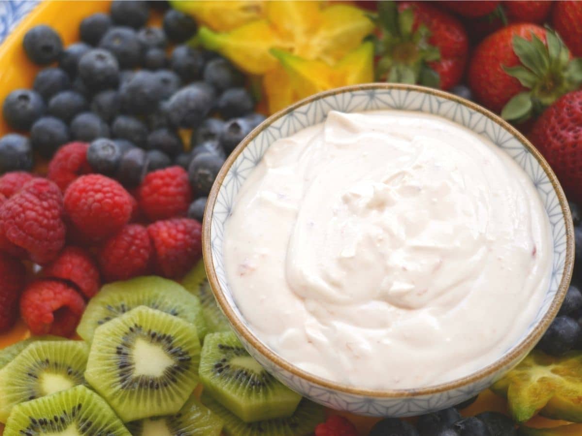 strawberry fruit dip in bowl with kiwi raspberries blueberries and starfruit