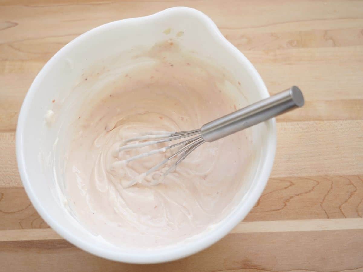 yogurt and cream cheese and strawberry jam and whisk in small mixing bowl