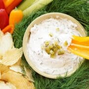 dill pickle dip in bowl with yellow pepper dipped in