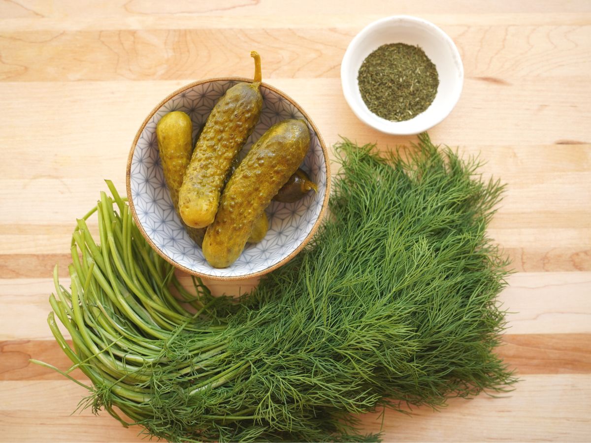 dill pickles, dried dill and fresh dill on cutting board