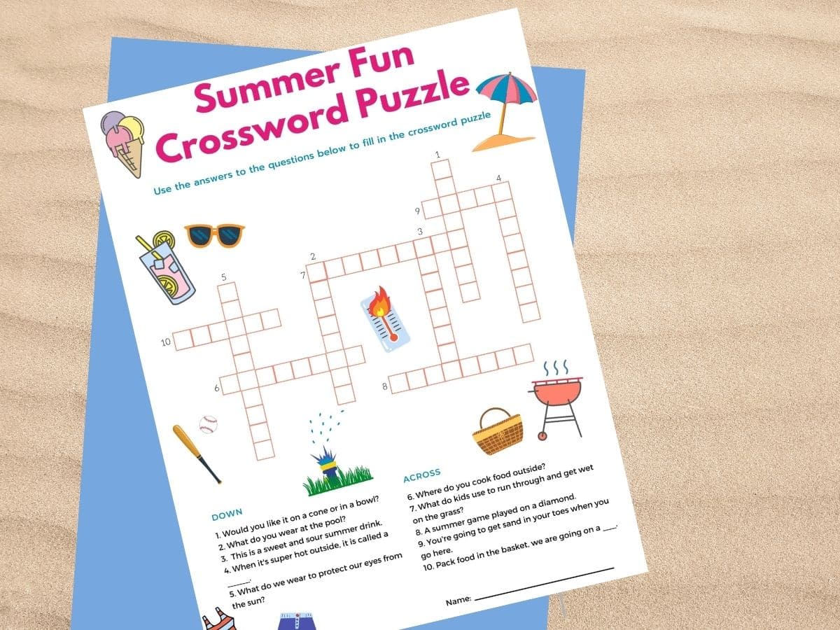 summer crossword puzzle printed out and resting on a sandy background