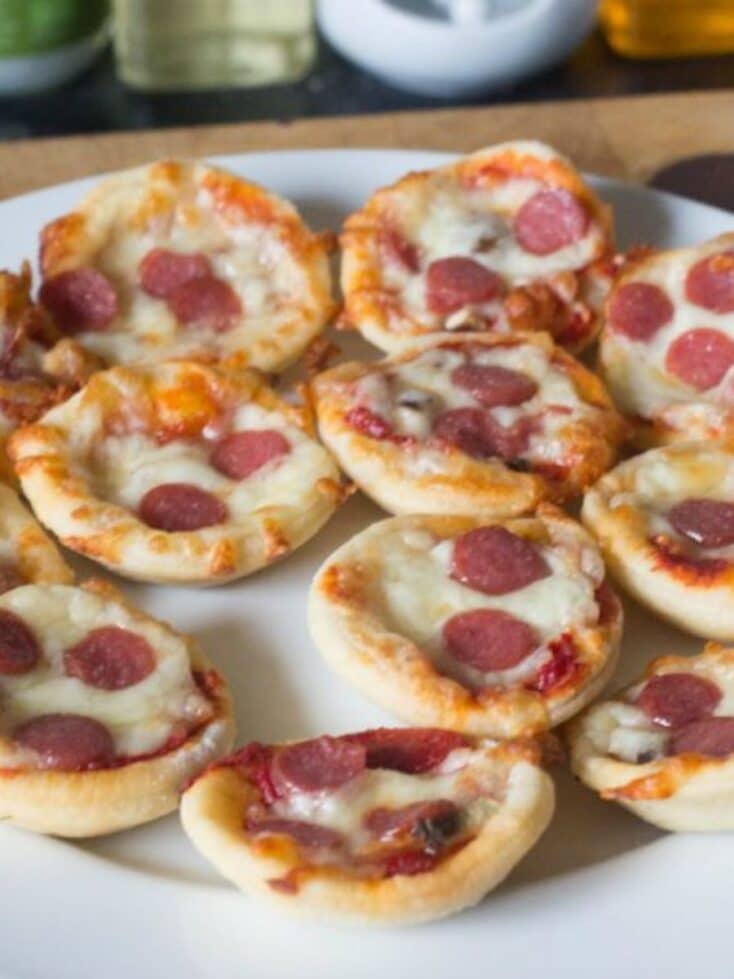 mini pizzas - bite sized on plate pepperoni pizzas