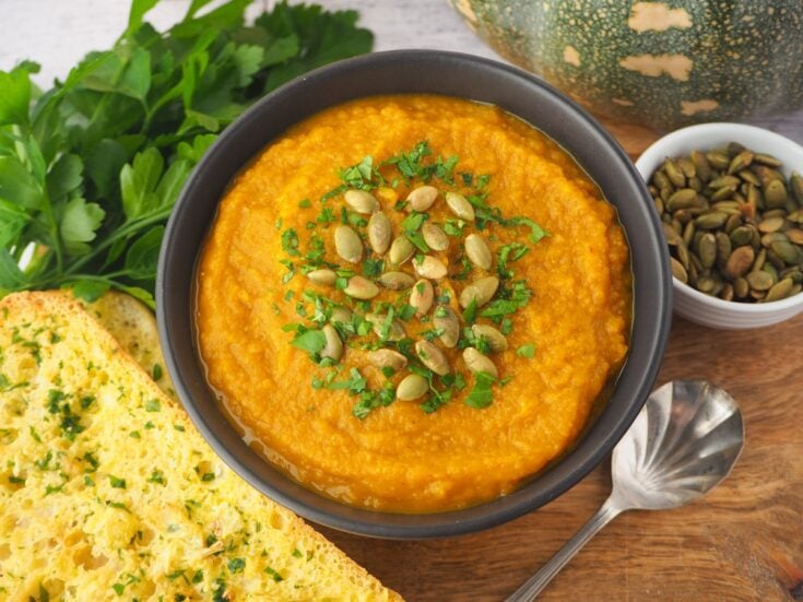 bowl of pumpkin soup with garlic bread