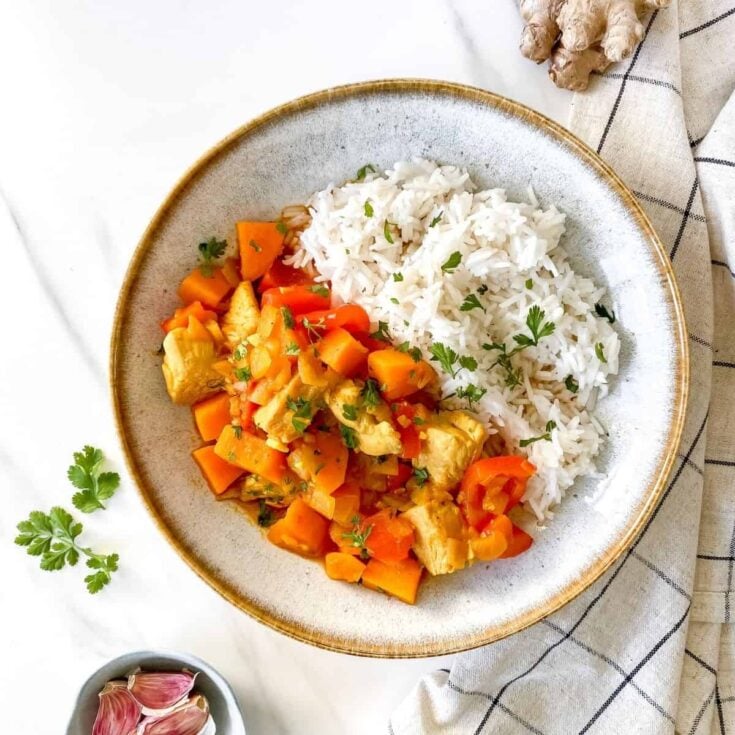 plate of spicy turkey stew with side of rice