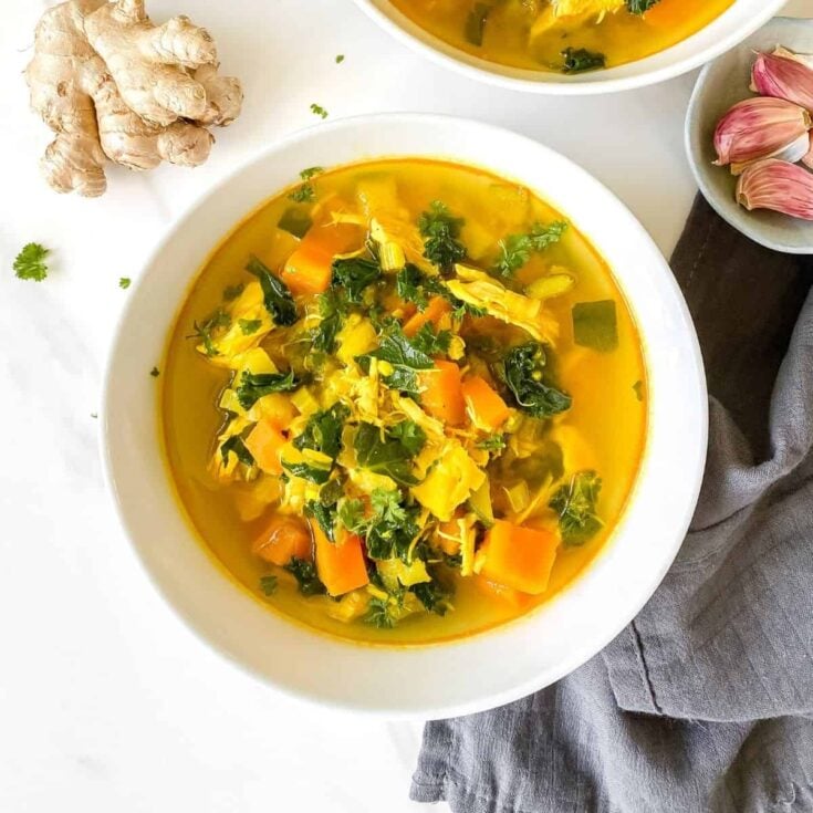 bowl of turmeric chicken soup with ginger