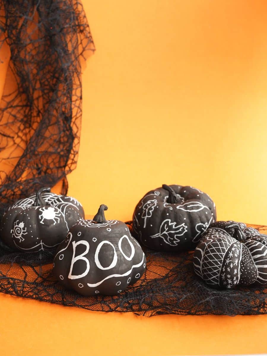 https://www.kitchencounterchronicle.com/wp-content/uploads/2022/09/4-chalk-marker-pumpkins-with-orange-background-and-black-lace.jpg