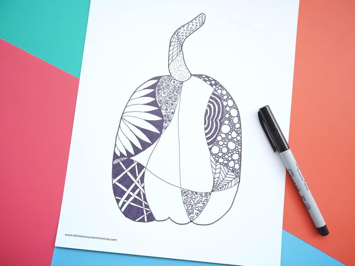 fall pumpkin zentangle design with zentangle patterns filled in with black sharpie