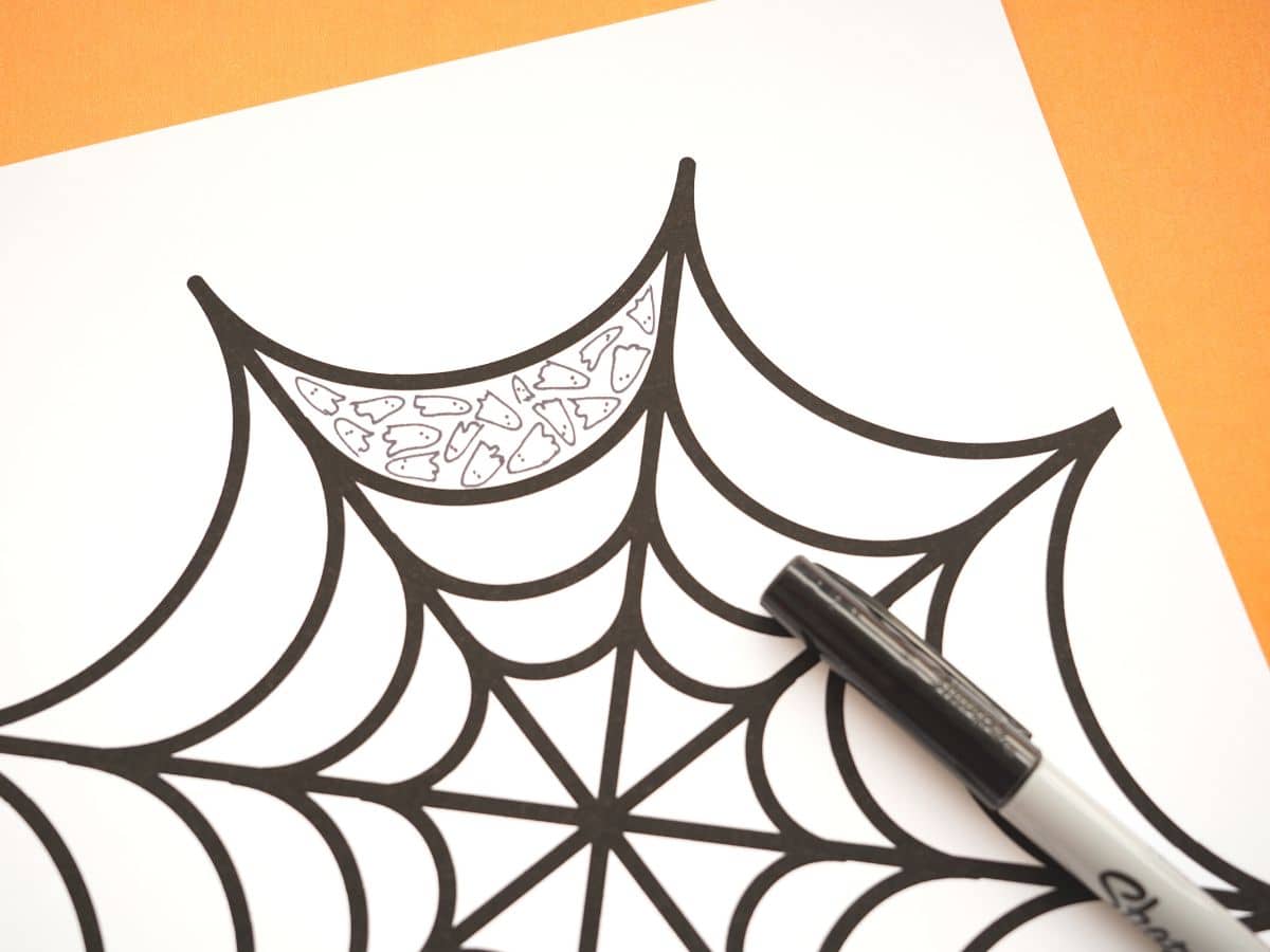 ghost zentangle pattern in a spider web with black marker