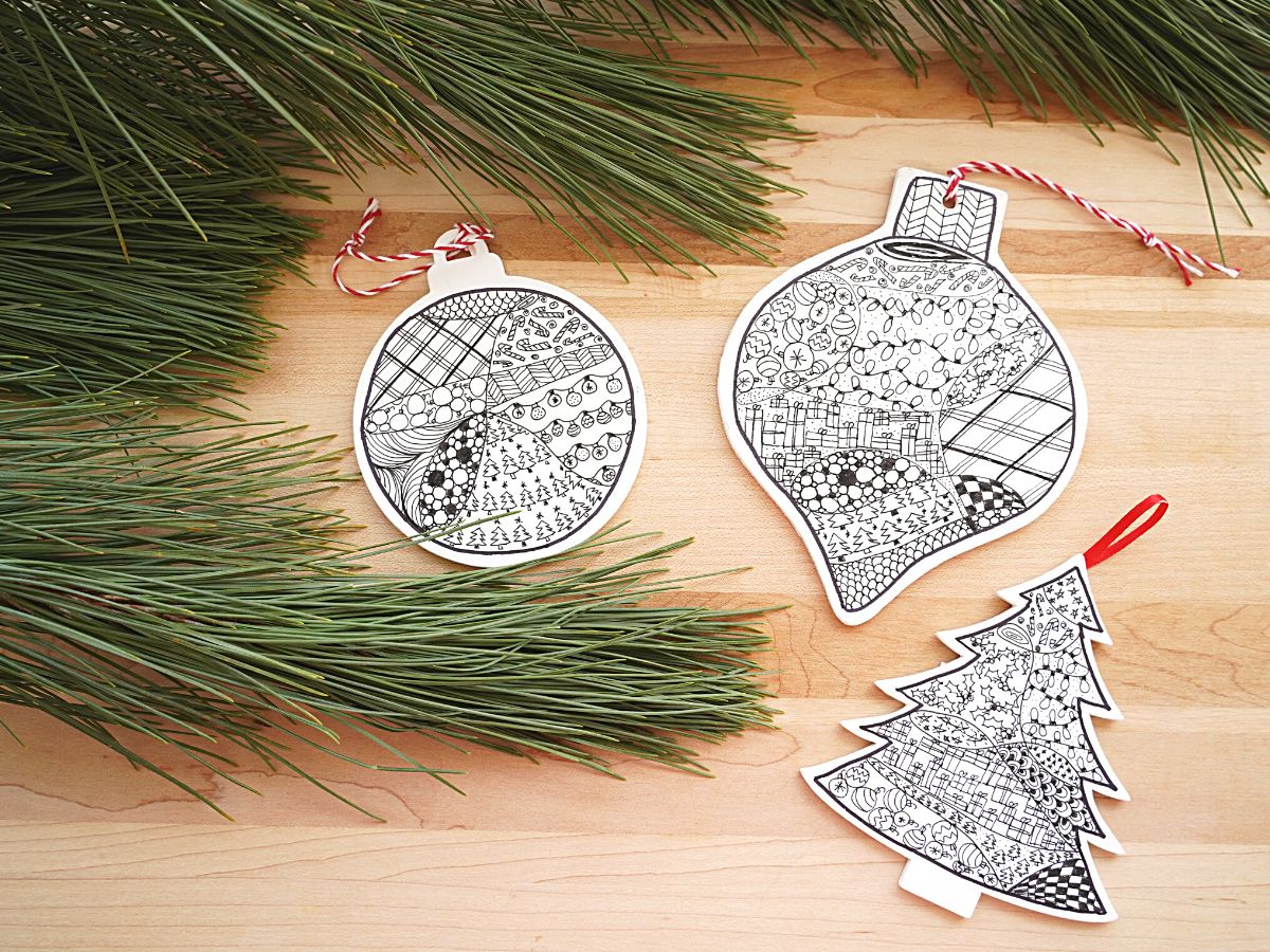 3 christmas ornament with zentangle christmas designs and a bough of a christmas tree