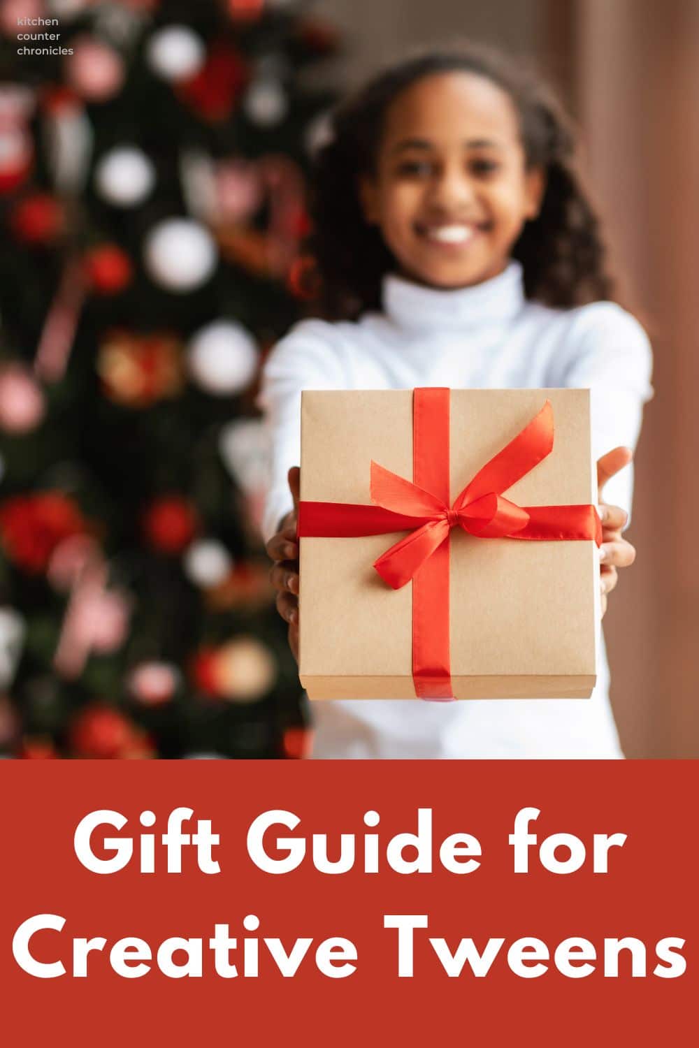 girl holding present in front of Christmas tree and title gift guide for creative tweens