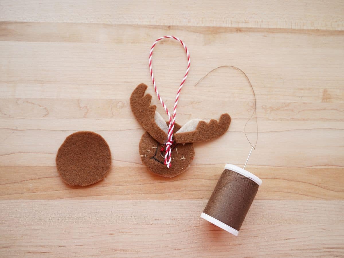 back of felt reindeer ornament head with spool of brown thread