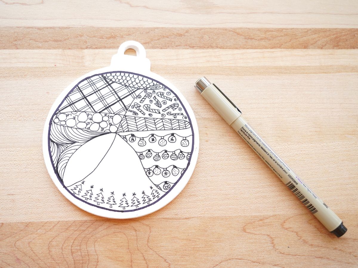 christmas ornament with part of a zentangle design drawn on with black marker