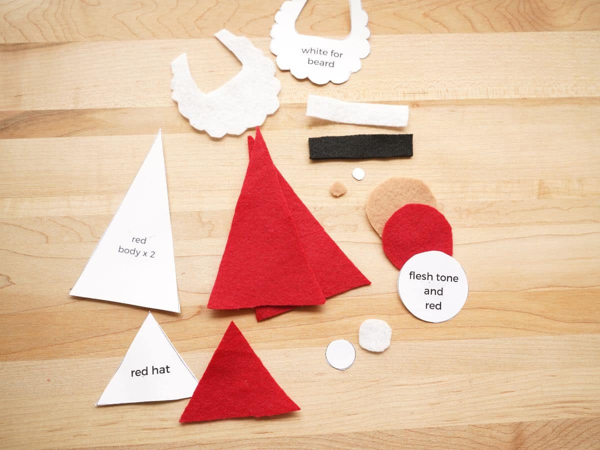 felt santa ornament pattern pieces cut out on wood table top