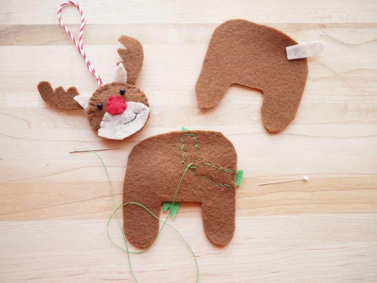inside of brown felt body piece of reindeer with stitches from scarf