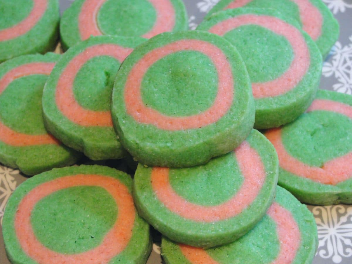 pile of simple festive christmas cookies that look like christmas ornaments sugar cookies on plate