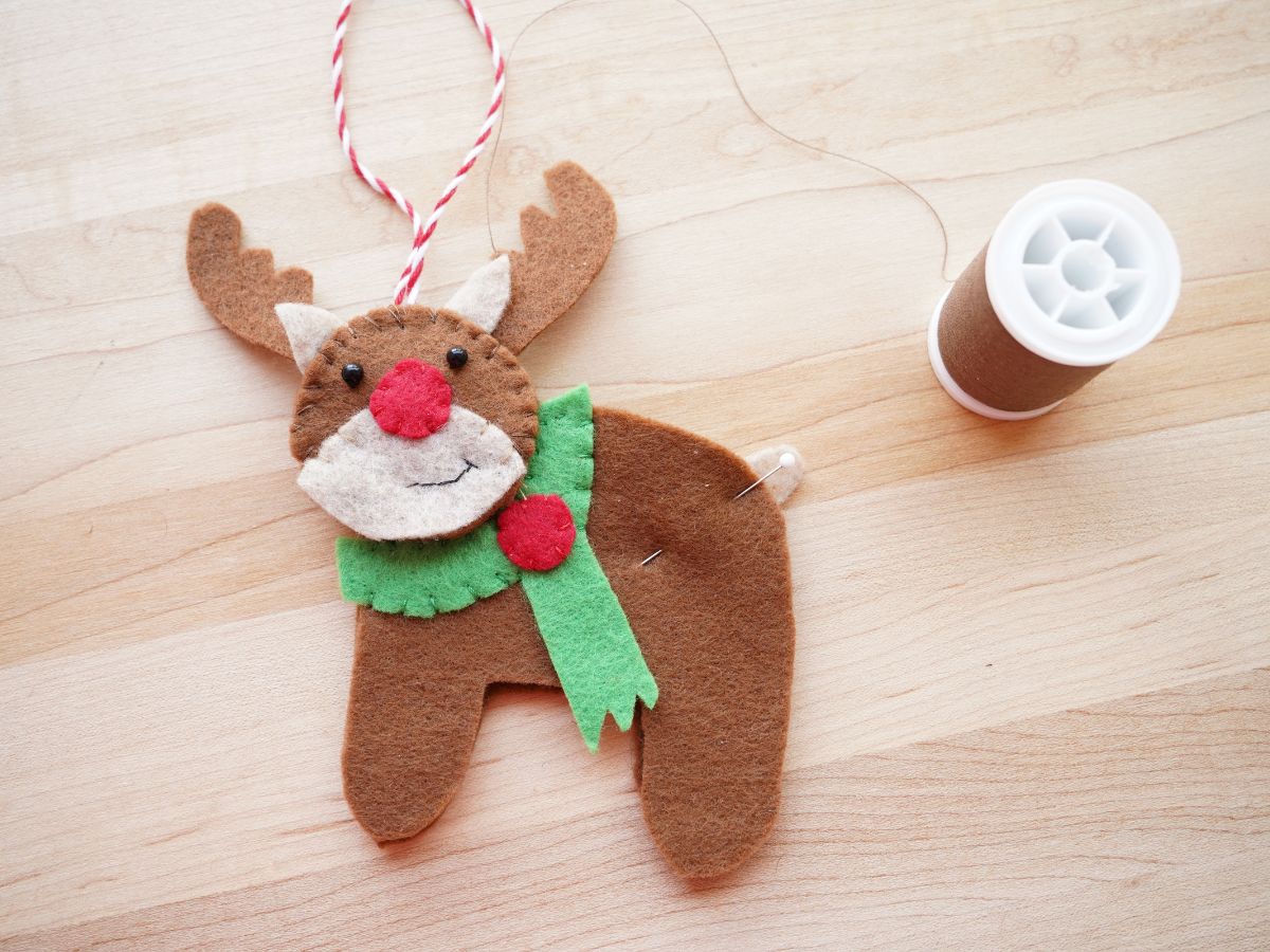 reindeer ornament with pin through felt tail and spool of brown thread