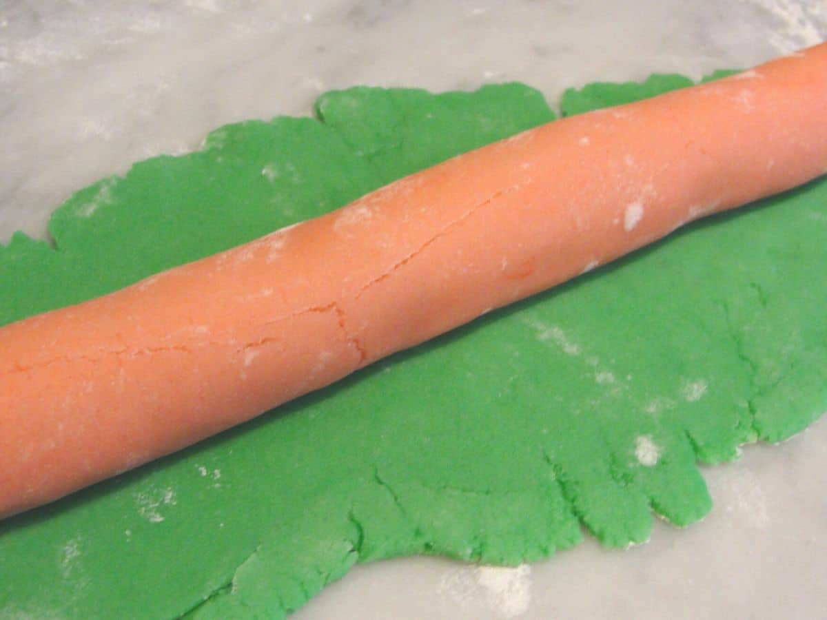 long snake of pink and green simple christmas sugar cookie dough on top of green cookie dough