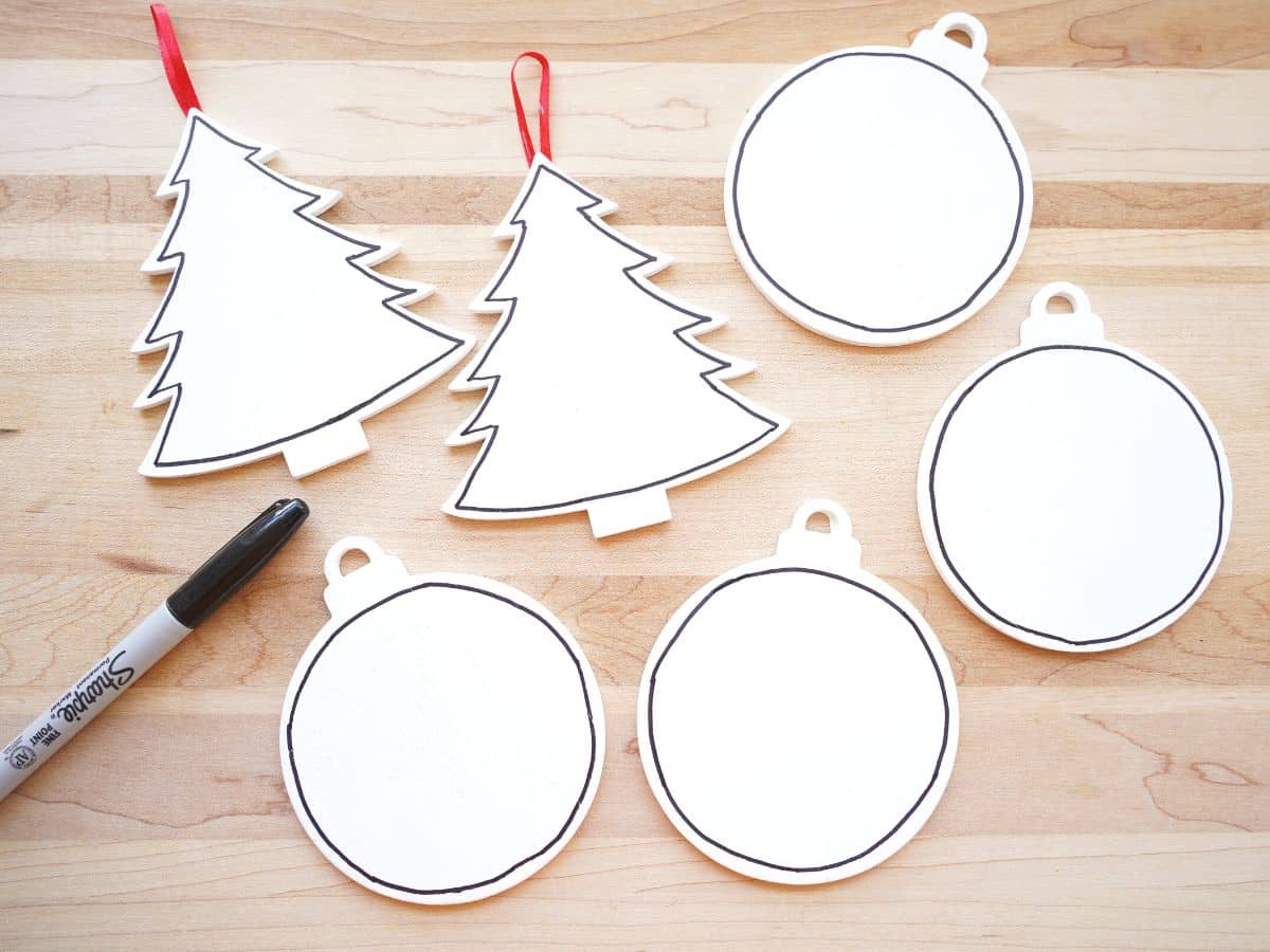 6 painted wooden christmas ornaments with black marker outline