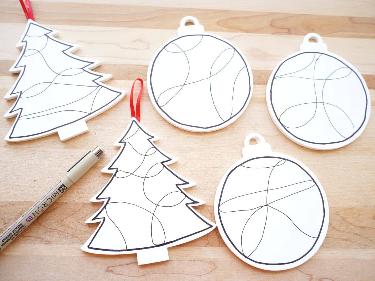 wooden christmas ornaments painted white with black zentangle lines