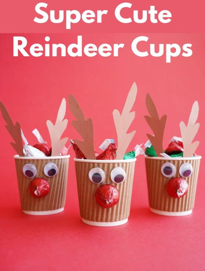3 reindeer cups filled with chocolate kisses with title