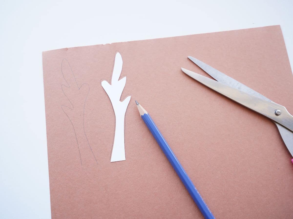 reindeer cup craft antler traced on brown construction paper with scissors and pencil