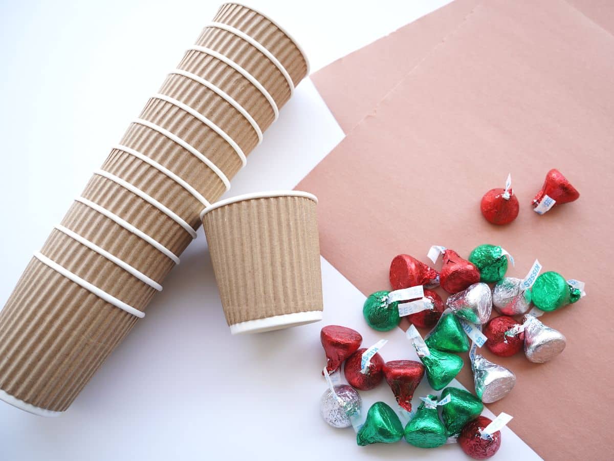 supplies for making reindeer cups brown paper cups, chocolate kisses and construction paper