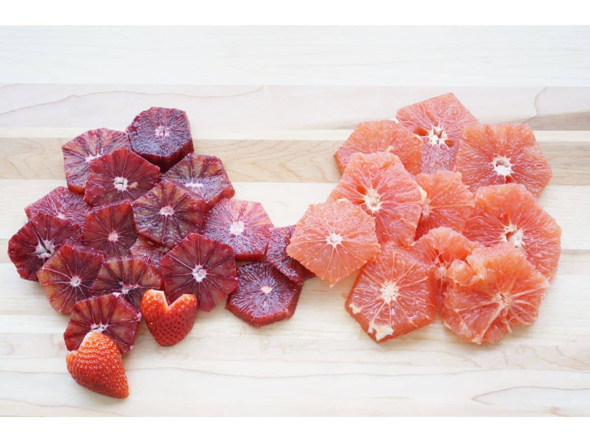 how to build a valentine heart shaped fruit tray first layers of orange and grapefruit slices on board