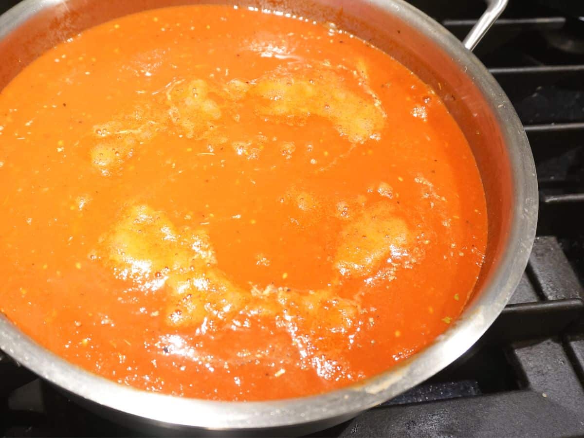 pan filled with easy marinara sauce for spinach stuffed pasta shells