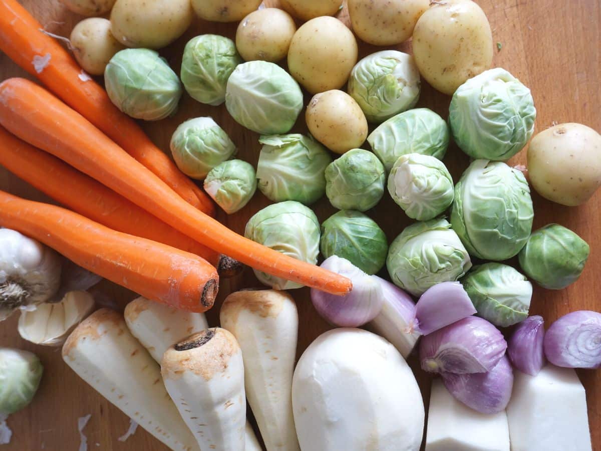 pile of vegetables for beef stew - potatoes, turnip, parsnip, carrots, brussel spouts and onion