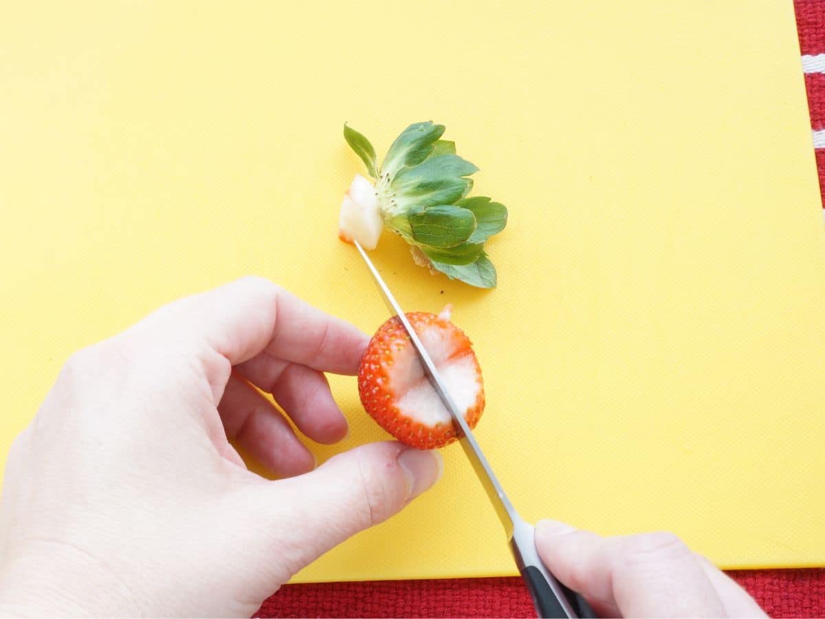 strawberry heart being cut in half lengthwise