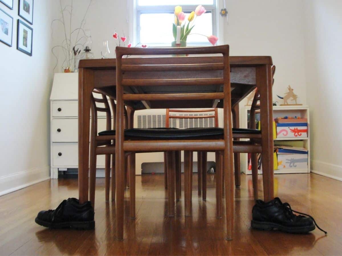 dining room table with shoes on legs of table