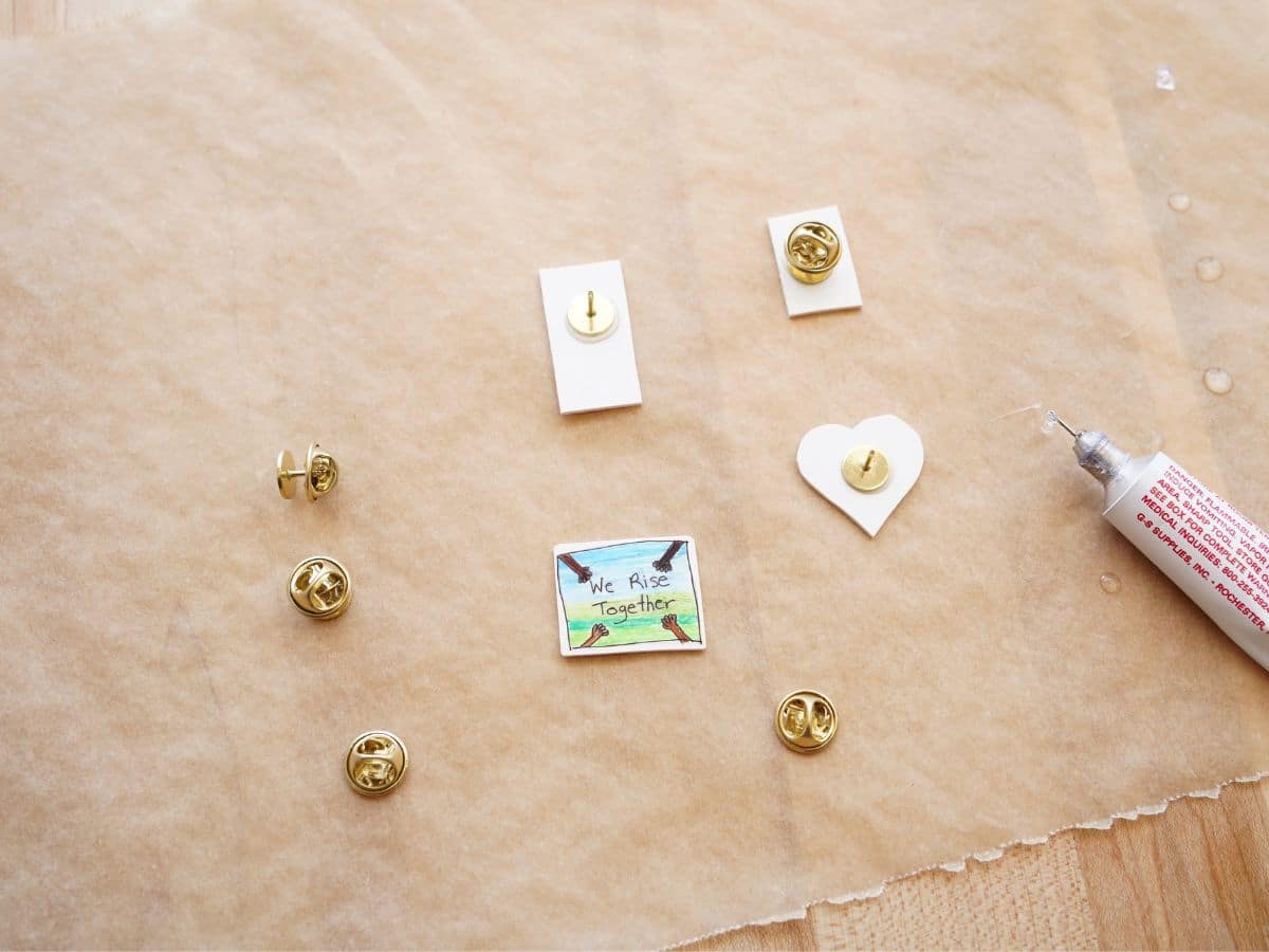 shrinky dink women's history month pins out of the oven on parchment paper