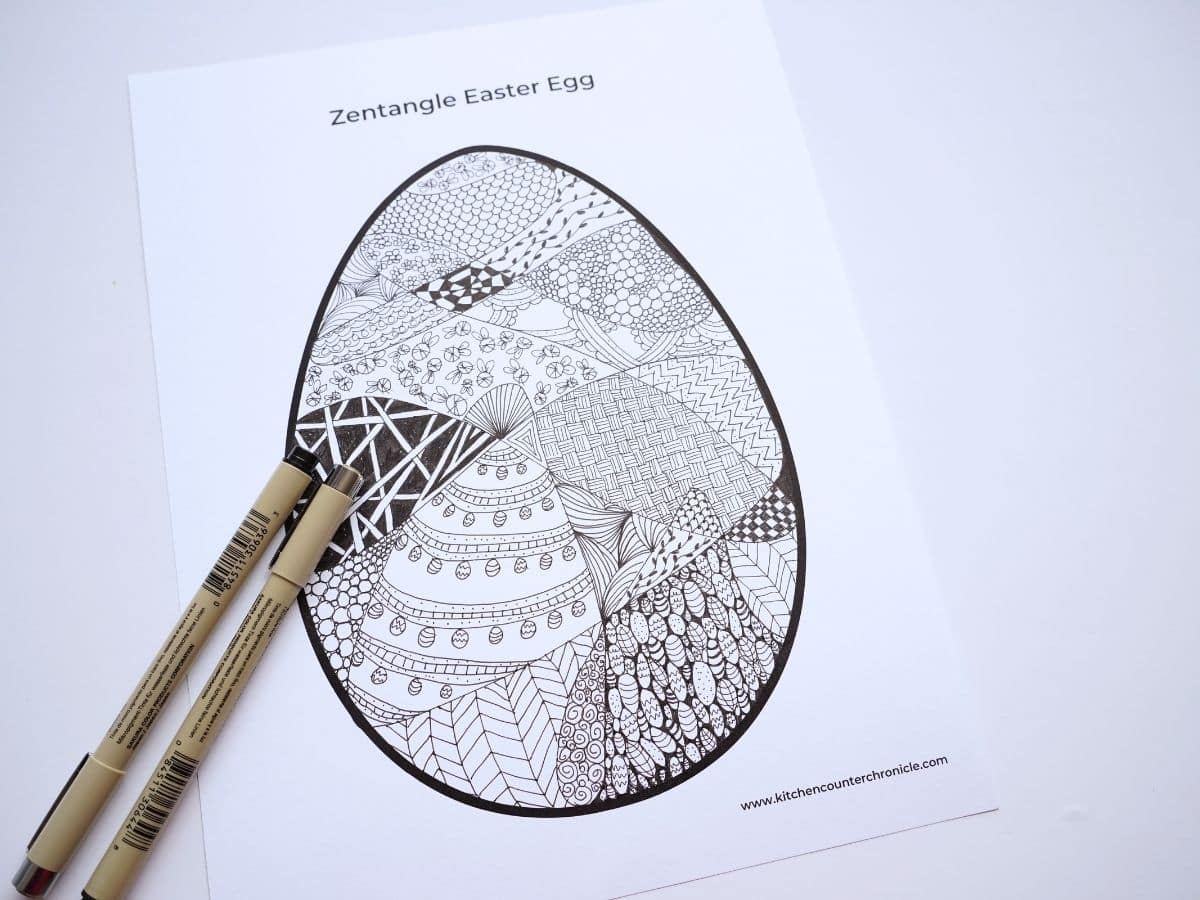 zentangle easter egg filled with zentnagle designs and two fine-tipped markers