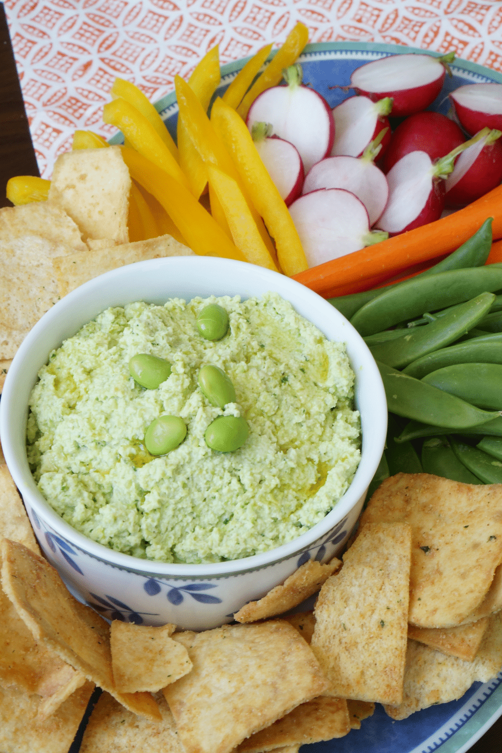 edamame hummus on platter with pita chips and vegetables