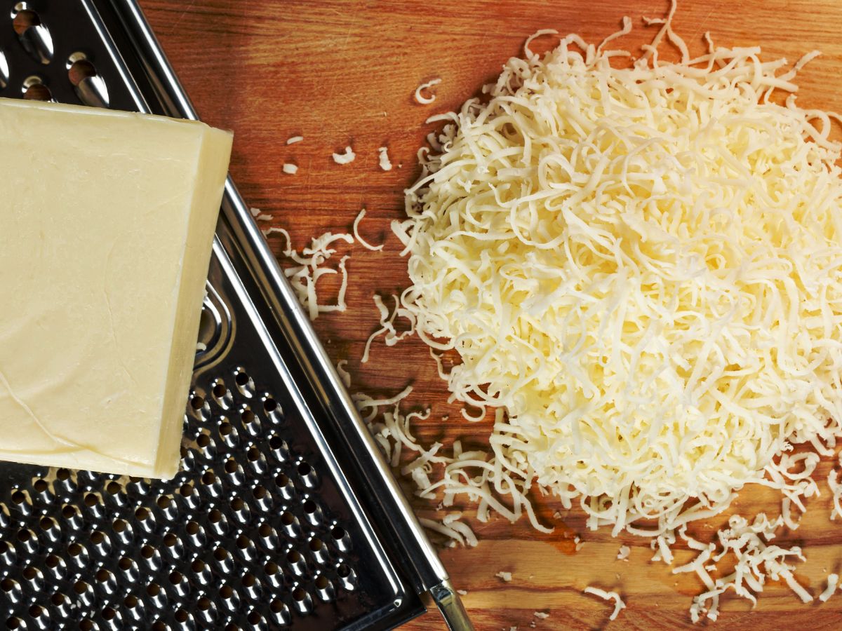 grated cheese on board with cheese grater