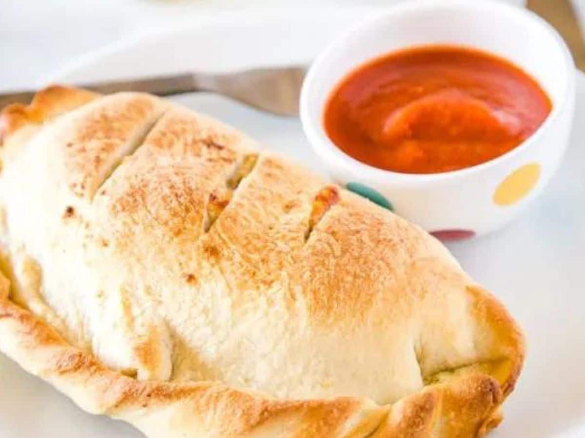 italian sausage stuffed calzone on plate