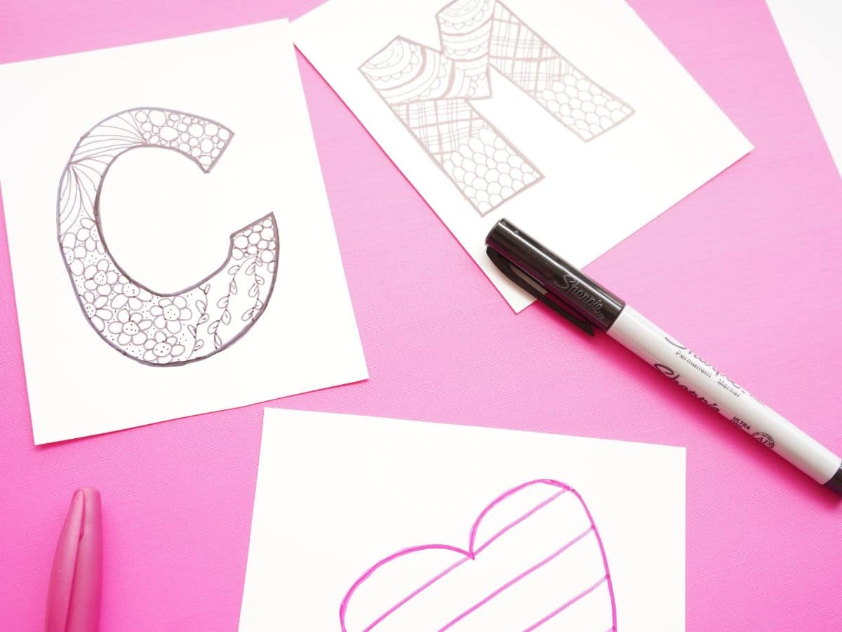 zentangle designs inside letter c and letter m on shrink paper