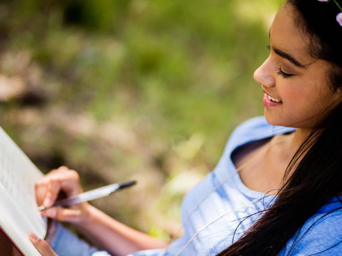 kid writing outside