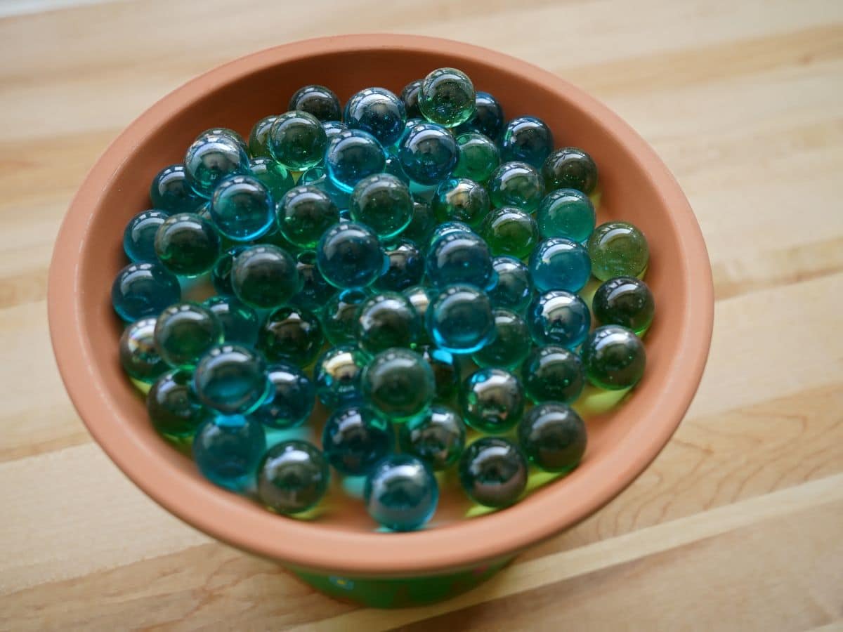 marbles poured into terra cotta pot bee waterer
