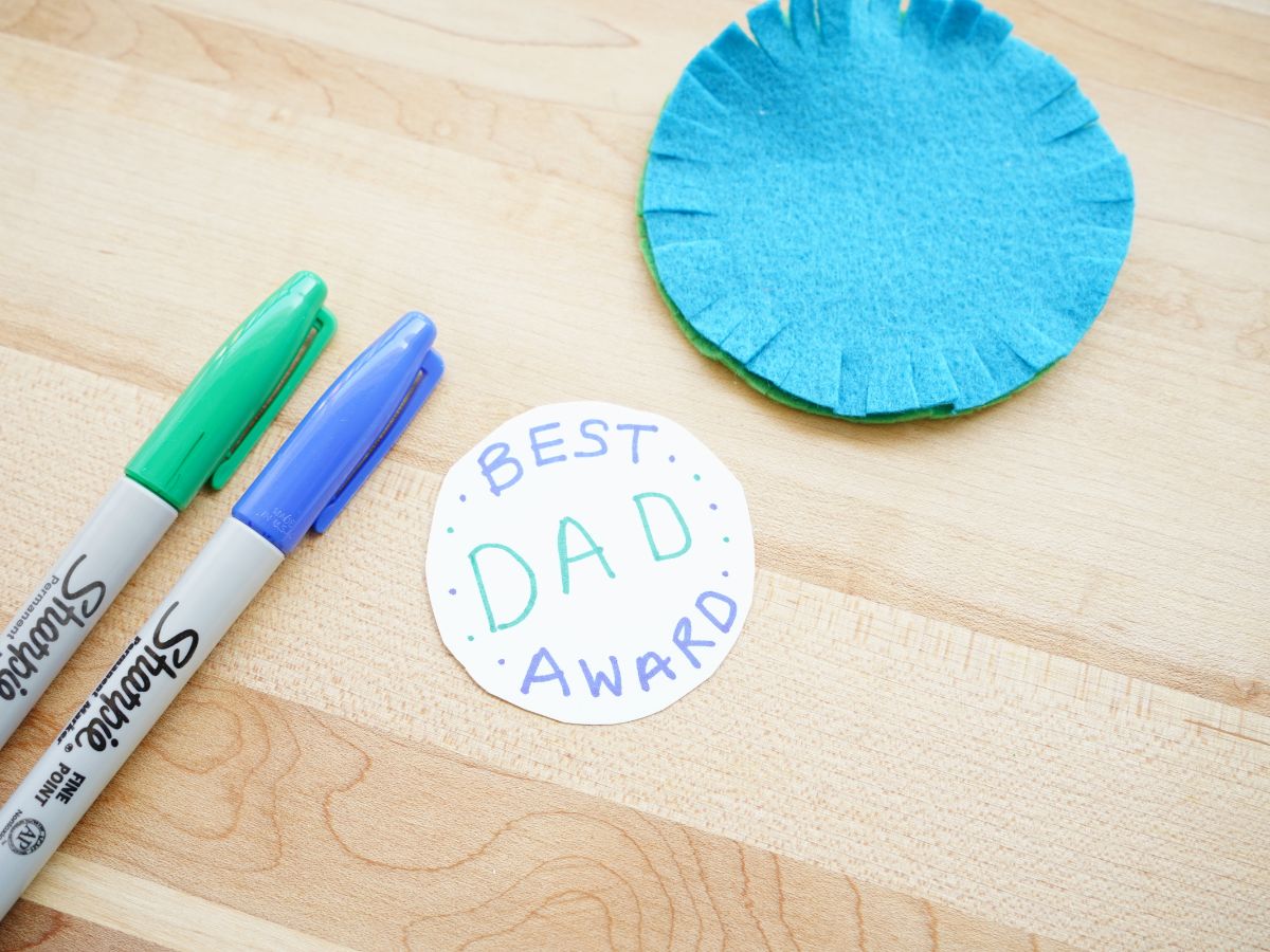 message written on best dad award with markers