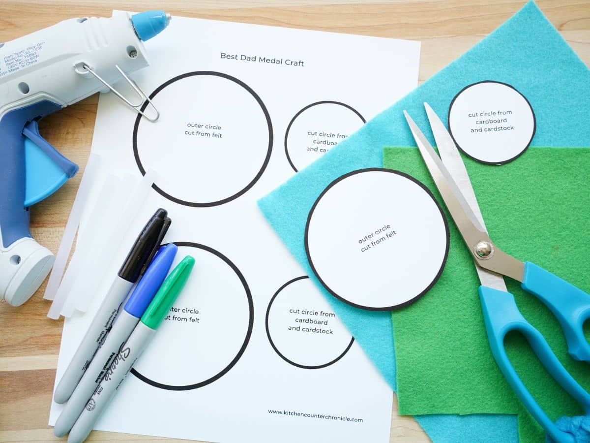 supplies for father's day medal craft - scissors, markers, printable template, felt and glue gun